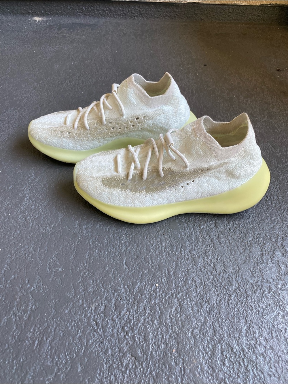 These Adidas Yeezy Boost 380 Calcite Glow sneakers feature a white Primeknit upp